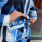 Person wearing a blue and black patterned robe with a blurred background