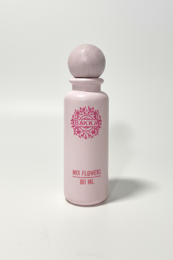 Pink bottle with wooden cap on a white background