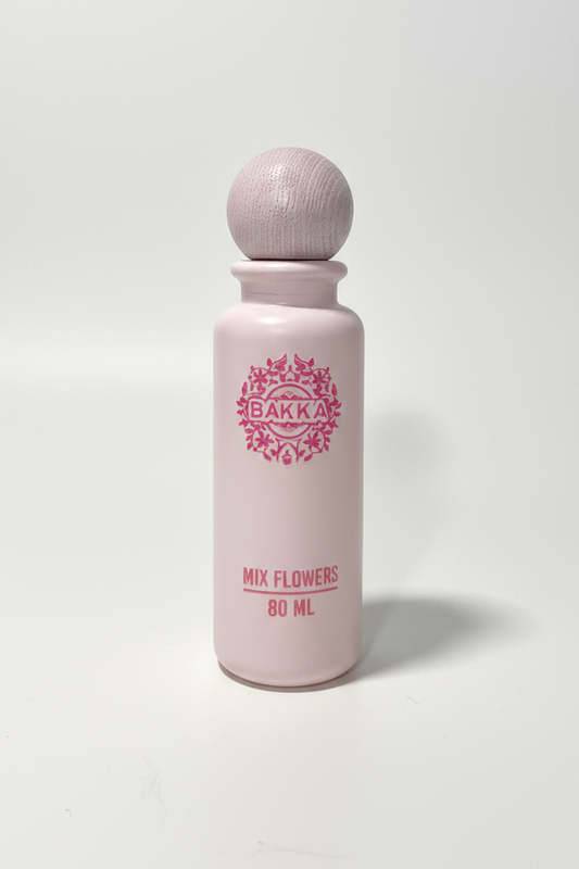 Pink bottle with wooden cap on a white background