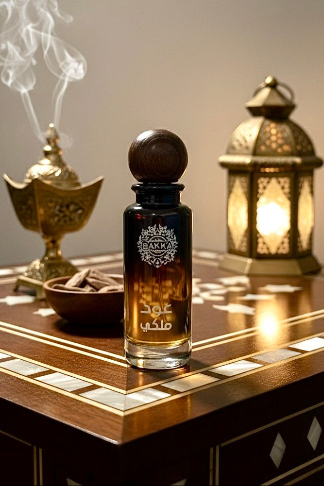 Perfume bottle with smoking incense and lantern on a wooden table